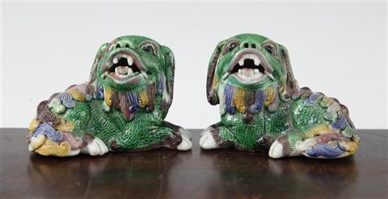 A pair of Chinese famille verte glazed biscuit figure of recumbent lion-dogs, 19th century, 10cm